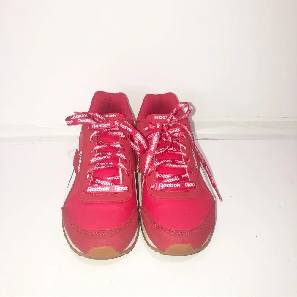 Reebok red classics with repeating logo strings.